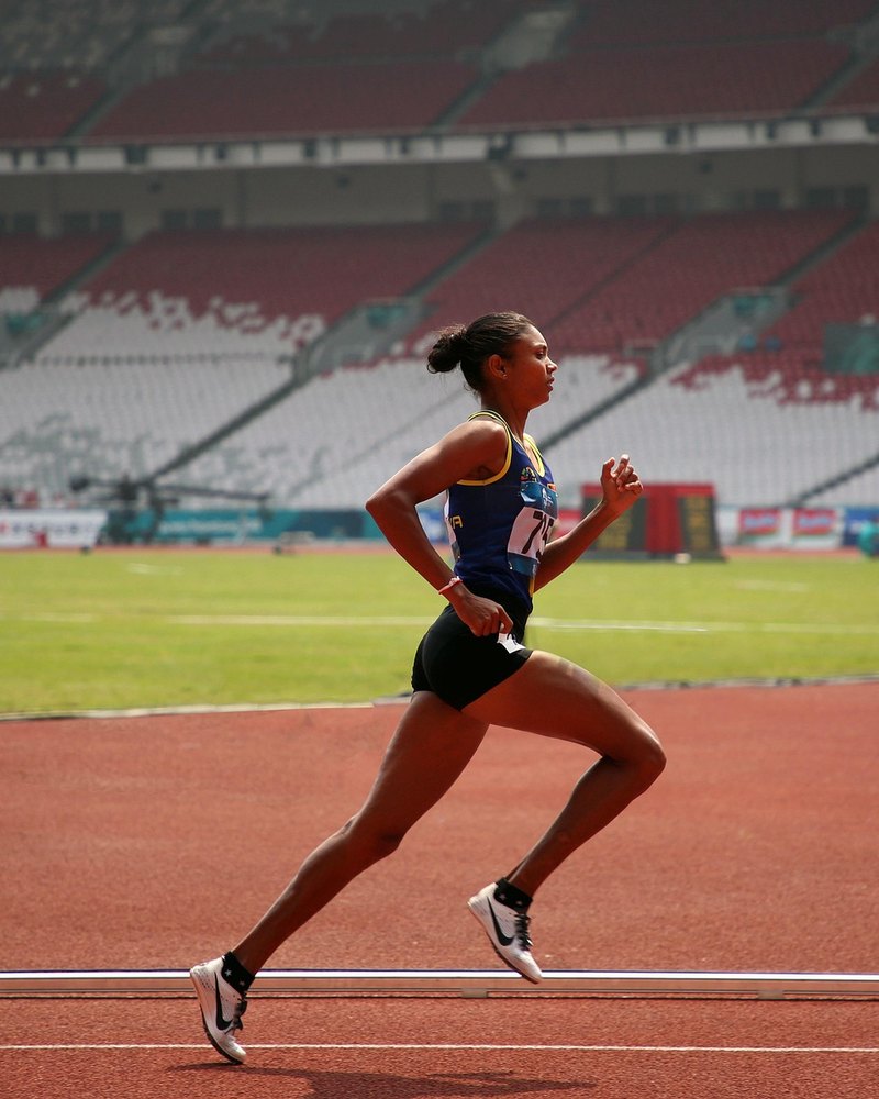 Female runner on the track in a stadium